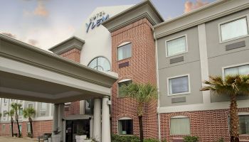 A hotel building with red brick and gray sections, labeled 