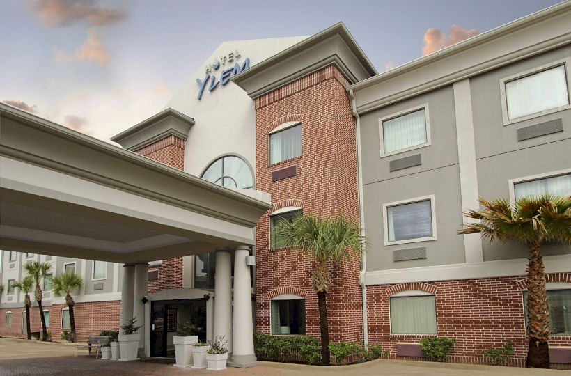 A hotel building with red brick and gray sections, labeled 