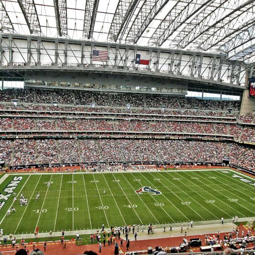 The image shows a packed football stadium with a clear view of the field, which has 