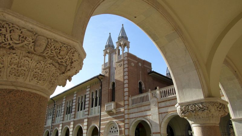 A photograph of a building with arches and towers.